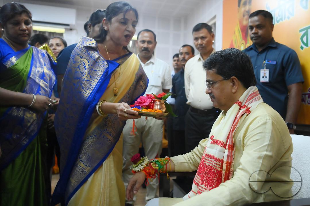 A lady tying rakhi and doing other rituals to Tripura CM Professor Dr