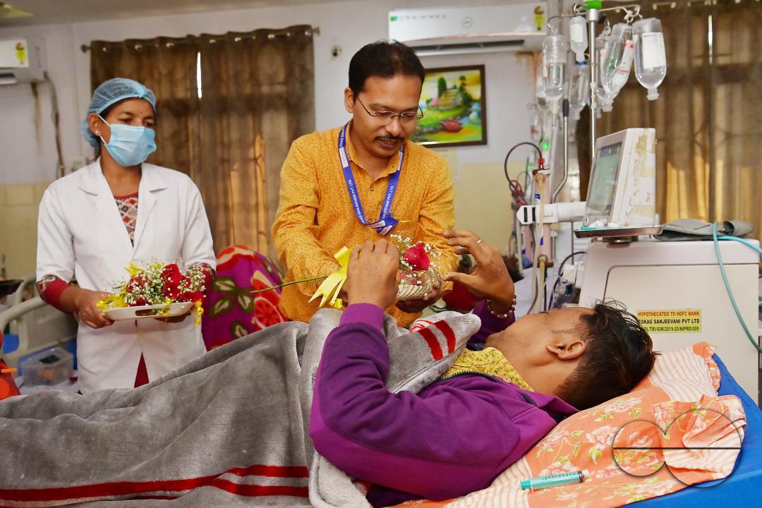 Doctors, along with health workers, distribute roses and fruits during the celebration of World Kindness Day in the dialysis ward at IGM (Indira Gandhi Memorial) Hospital in Agartala