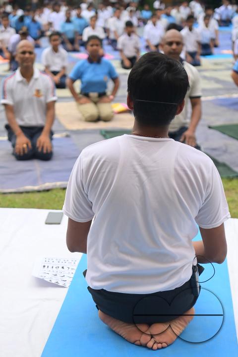 NCC cadets and officials perform yoga during 10th International Day of Yoga Day at BBM College Ground in Agartala
