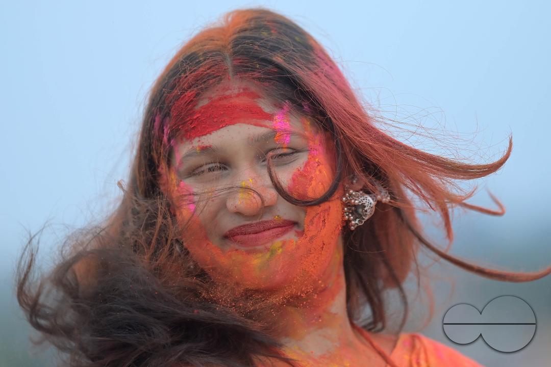 Indian girls adorned with 'Gulal' or coloured powder during the Hindu spring festival 'Holi', the festival of colour in Agartala