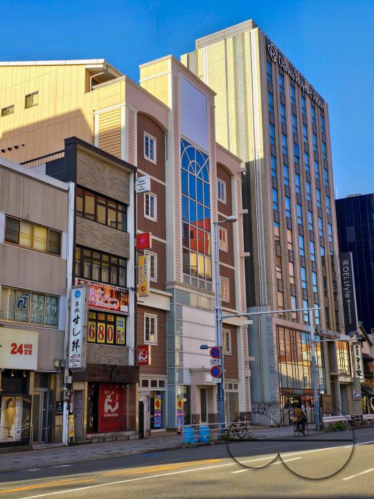 Multi coloured narrow buildings line the street in Fukuoka