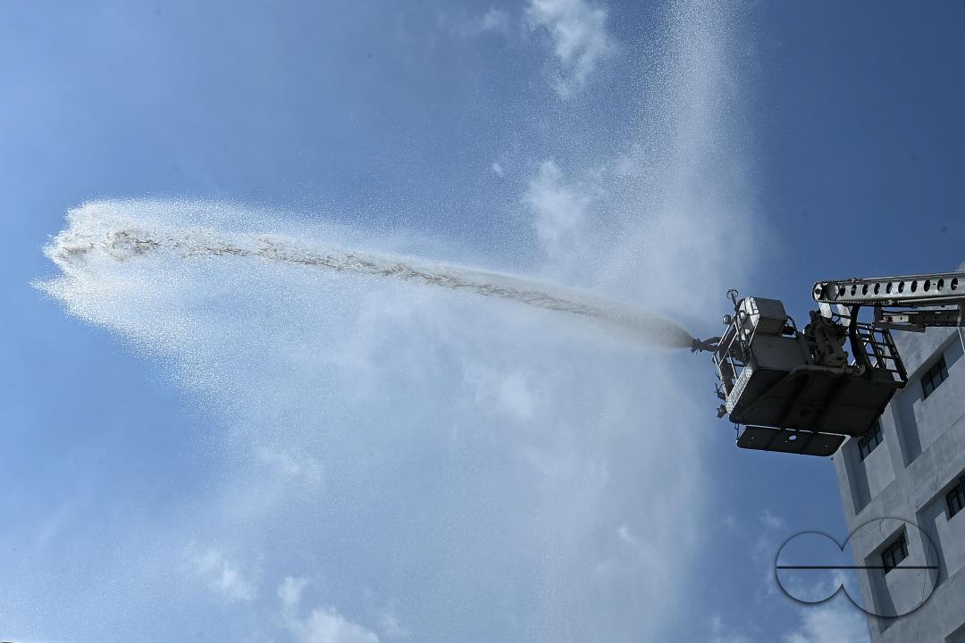 Fire brigade personnel are trying to control a fire on the top of the building of the dental college during a state level mock exercise on earthquake day at Agartala