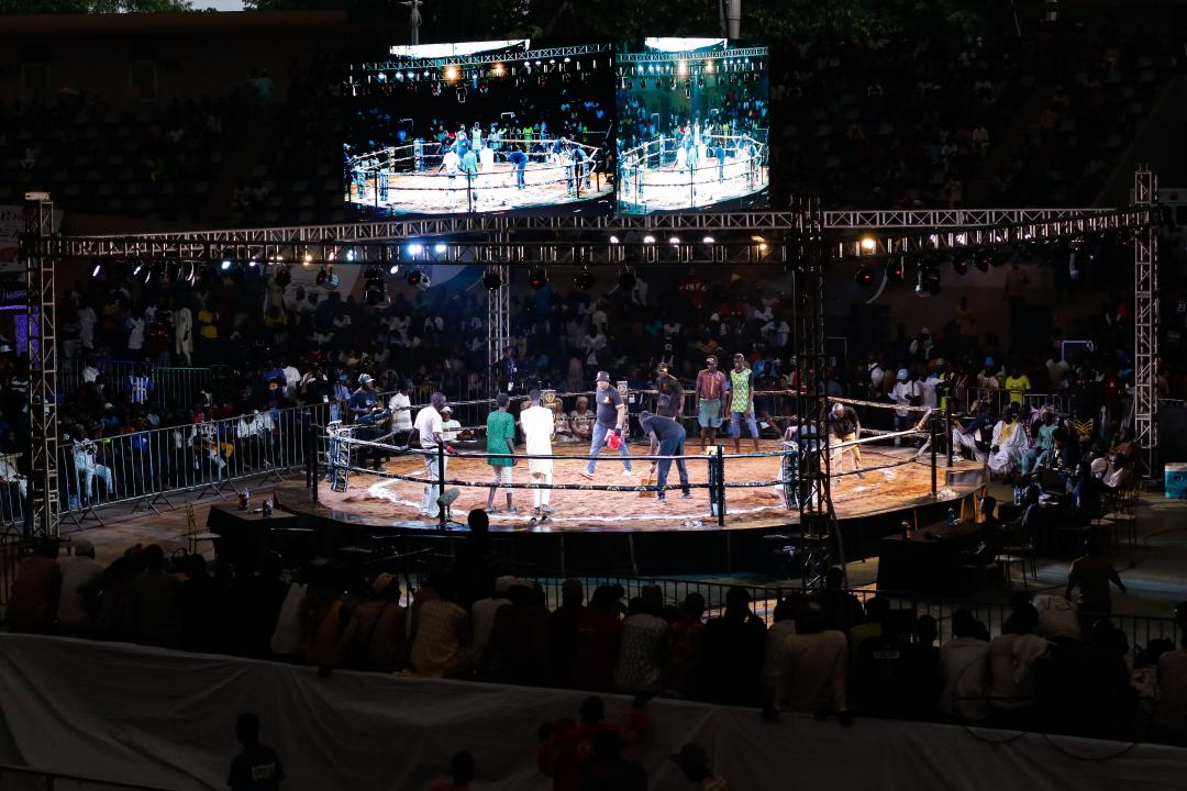 People watch Dambe boxers fight during the Dambe Warriors Supper fight 3 Tournament in Abuja, Nigeria.