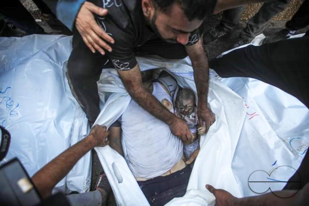 People wait to carry out dead bodies of Palestinians, who lost their lives during the attacks of Israel, from the Shifa Hospital, and to perform funeral prayer for them as Israeli airstrikes continue on the 6th day in Gaza City