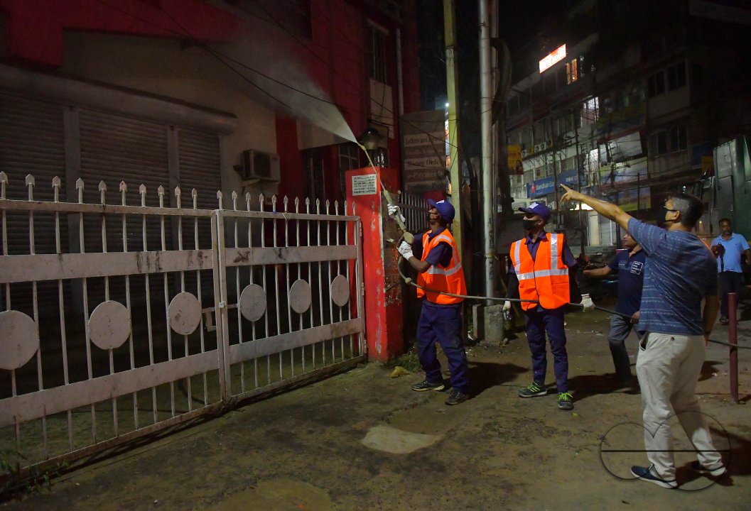 Workers Spray Disinfectant to Contain Coronavirus
