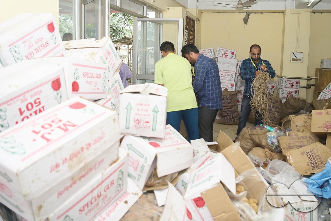 Government officials and workers are preparing food packets to be distributed by NDRF (National Disaster Response Force) personnel from helicopters to flood victims in different parts of Tripura