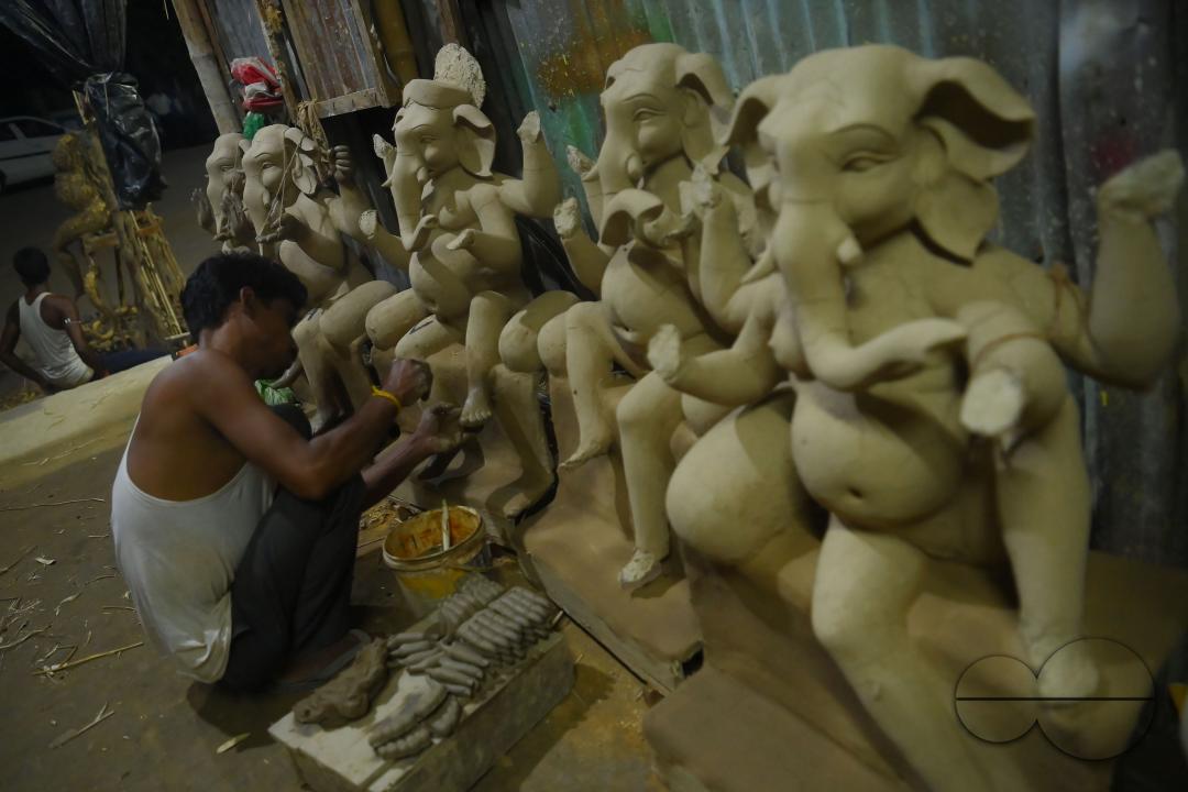 An Idol maker making idols of Lord Ganesh in a studio for the upcoming Ganesh Chaturthi festival at Agartala
