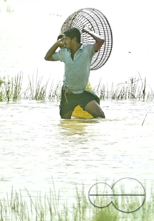 People fishing in a flooded agricultural field using traditional fishing methods in Bishalgarh, 17km away from Agartala