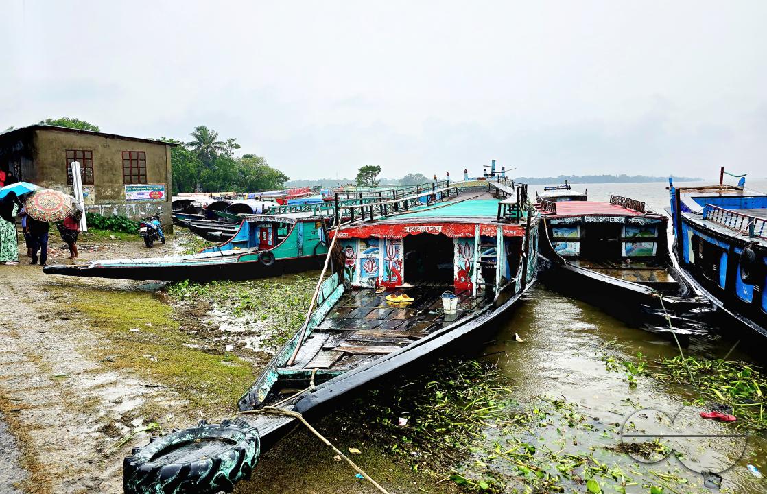 Two launches, used for ferrying passengers and goods, berthed at the shore of Dingapotha, Mohonganj âhaorâ (a large body of wetland formed by river and rain water, famous as a fishing area)