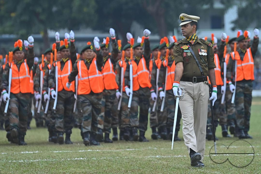 Troopers from the NDRF, Home Guards and Civil Defence take oath on the 61st All India Civil Defence and Home guards raising day at the police parade ground in Agartala