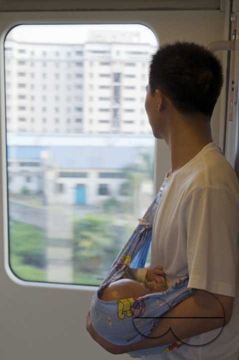 CHINA Migrant workers from the countryside returning home with baby by train from Guangzhou, Guangdong province.