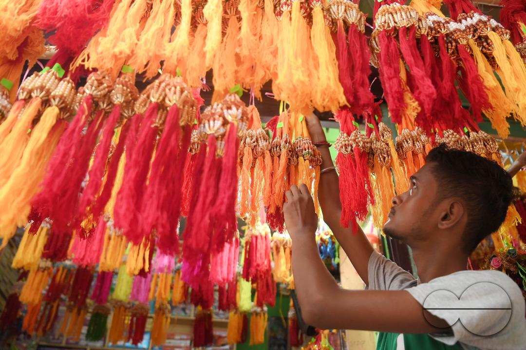 A shop owner arranging "Rakhi", sacred threads for the upcoming "Raksha Bandhan" festival at his shop in Agartala