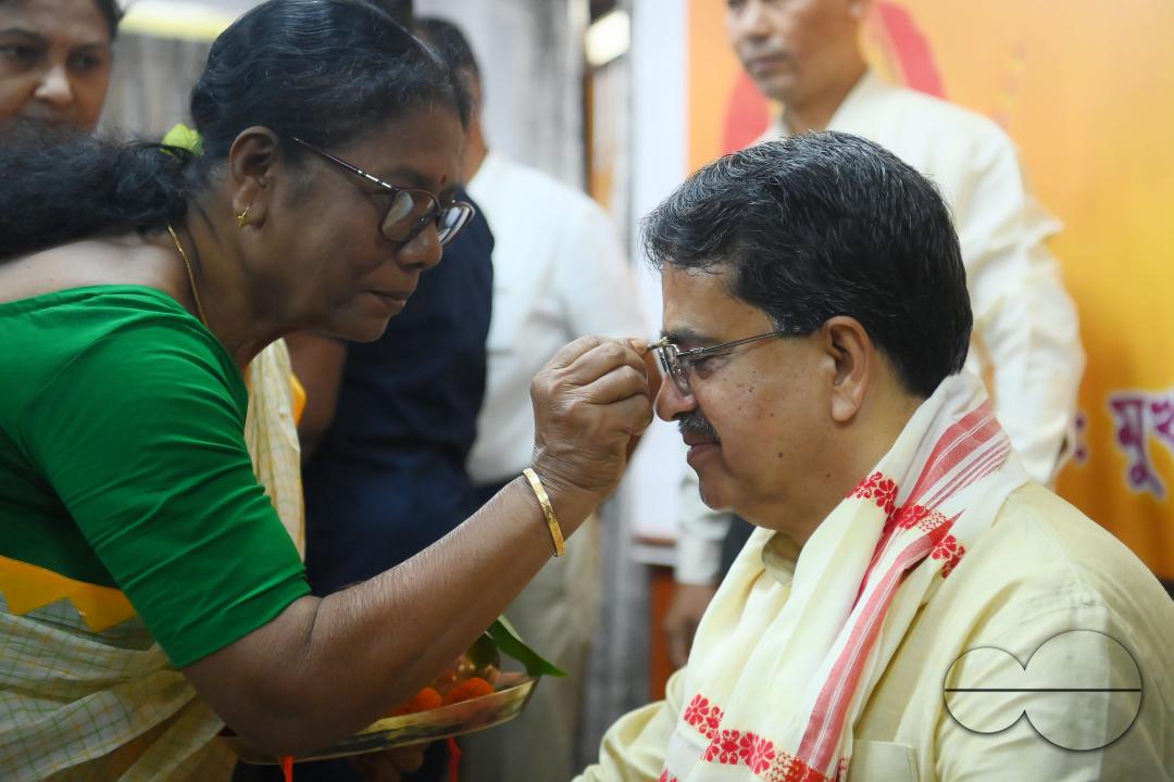 A lady tying rakhi and doing other rituals to Tripura CM Professor Dr