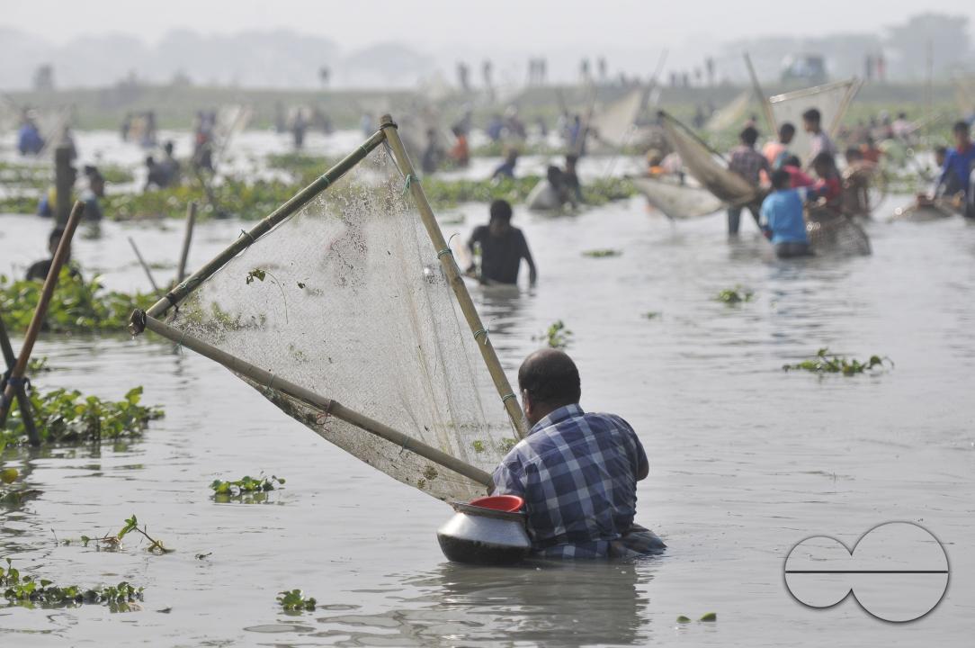 Rural people armed with Bamboo fish traps and handmade fishing nets take part in celebrating in a 100-year winter polo bawa fishing festival at the Gowahori beel of Biswanath upazila in Sylhet