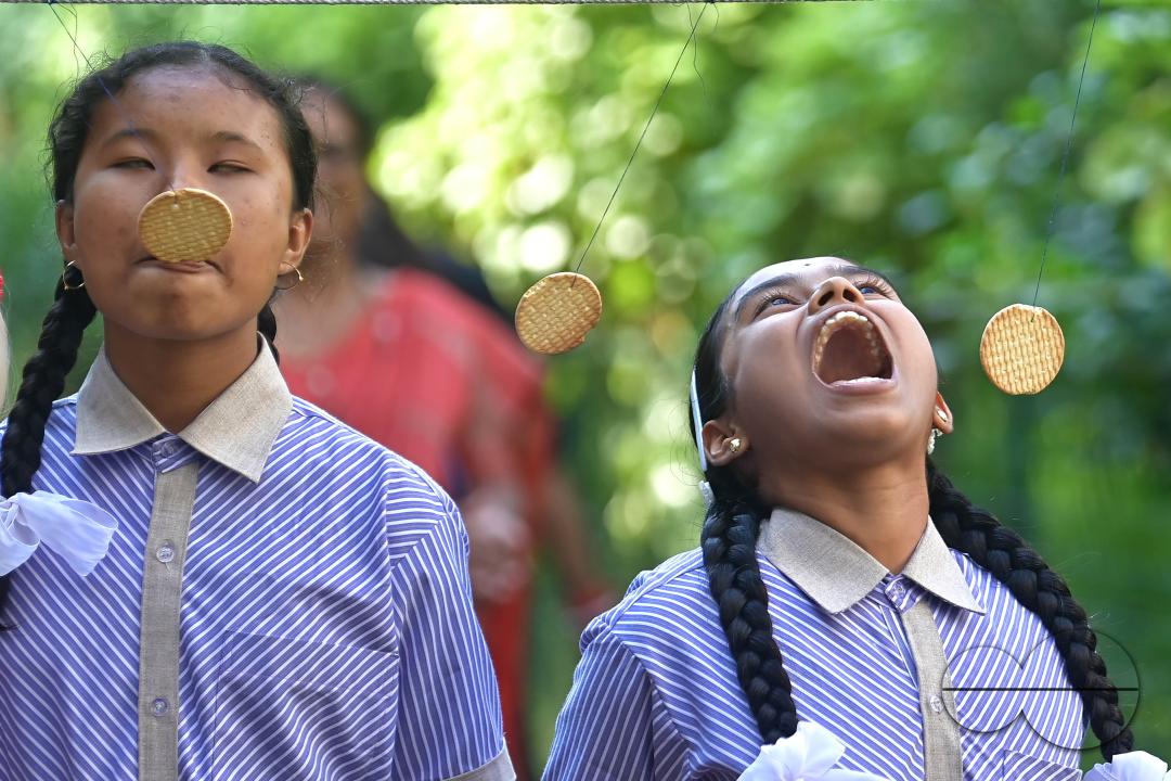 Students at the Institute for Visually Handicapped are participating in a 'Biscuit Race' during the 'Children's Day' celebration at the institute's campus in Narsingarh, in Agartala