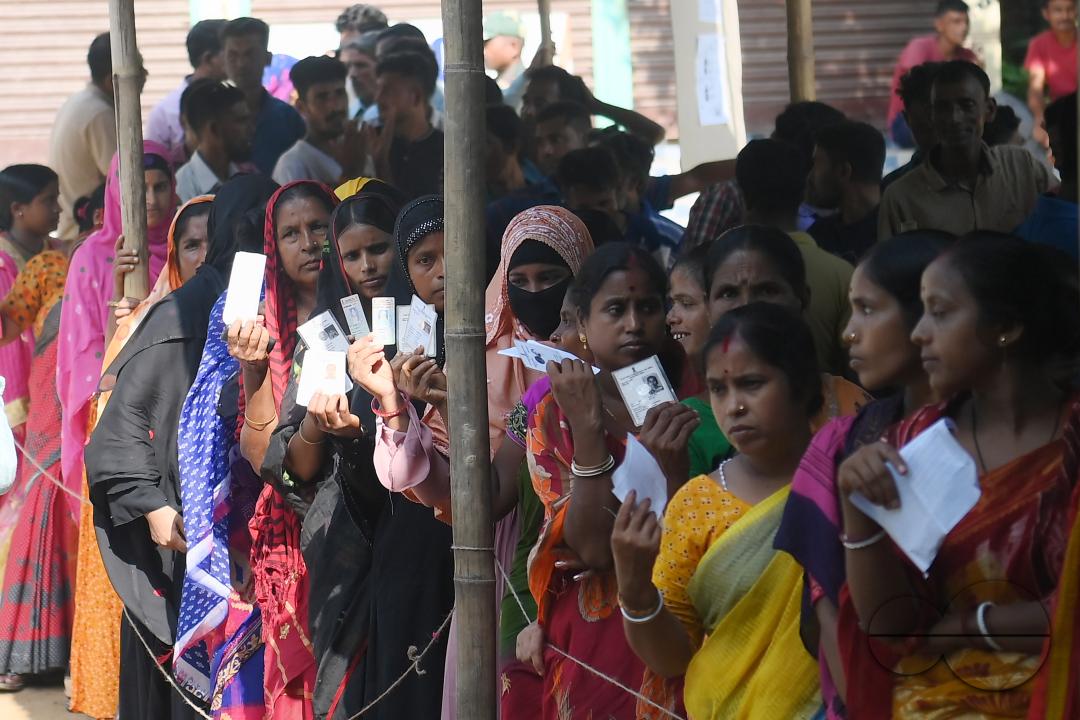 Voters wait in a queue to cast their votes during the by-elections for the Boxonagar assembly seat, in Tripura Sepahijala district