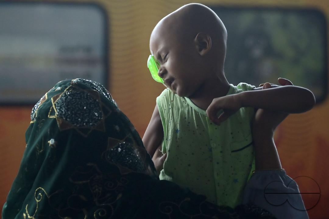 A mother and daughter at the railway station waiting for the interstate train which got cancelled during Cyclone Remal in Agartala