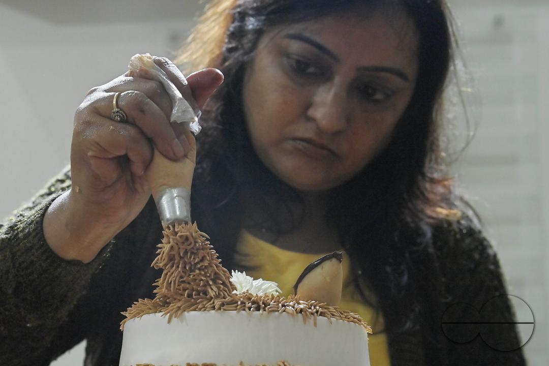 Sutapa Choudhary, a cake artist and teacher, making cakes at her cake parlour, "CREAMY DELIGHTS"