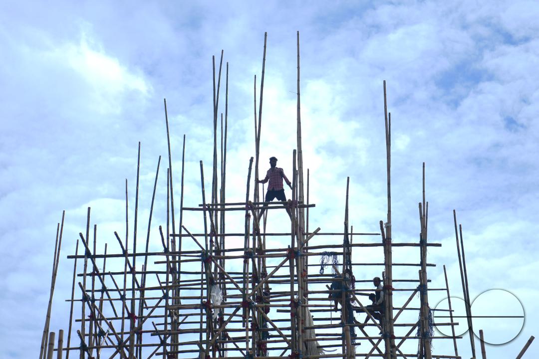 Workers are making a temporary bamboo structure, locally called "Pandal", for the upcoming Durga Puja in Agartala