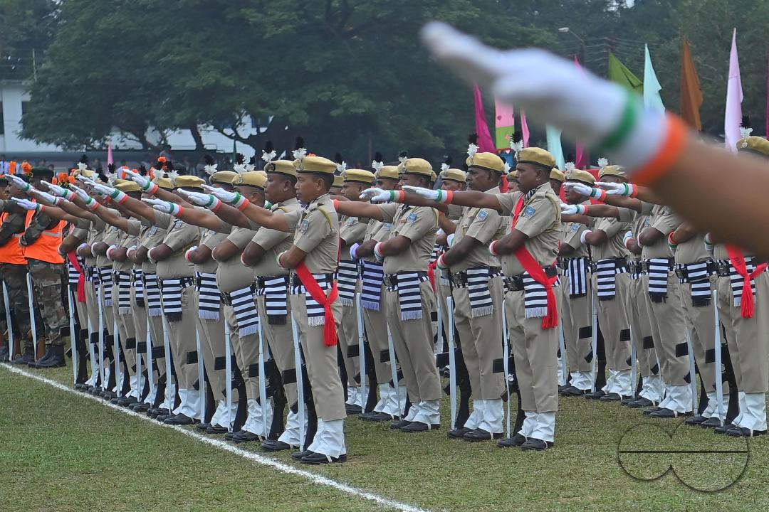 Troopers from the NDRF, Home Guards and Civil Defence take oath on the 61st All India Civil Defence and Home guards raising day at the police parade ground in Agartala