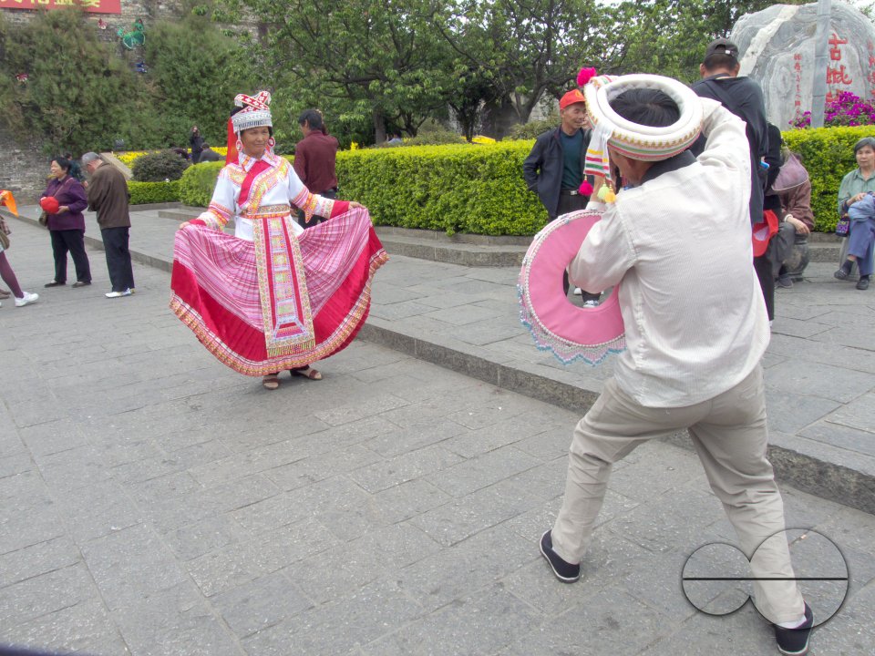 CHINA Chinese tourists photographing Ethnic Bei women dressed in traditional costume in Dali, Yunnan province.