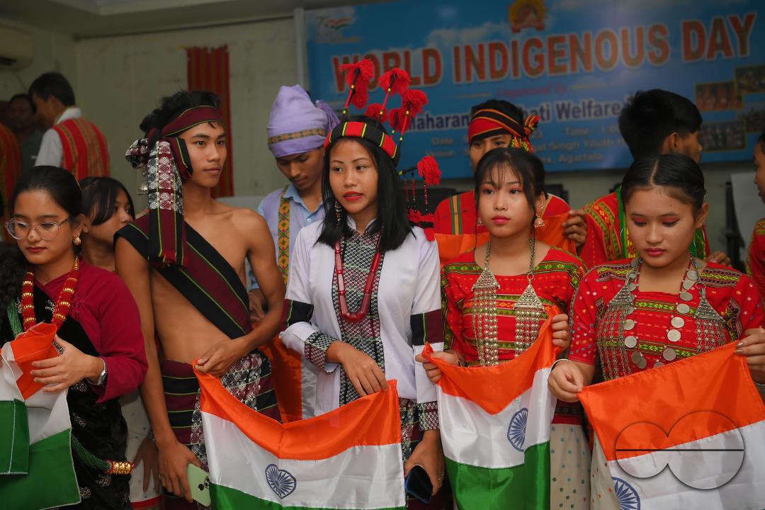 Indigenous girls holding the national flag during a cultural program on the occasion of World Indigenous Day at an auditorium in Agartala