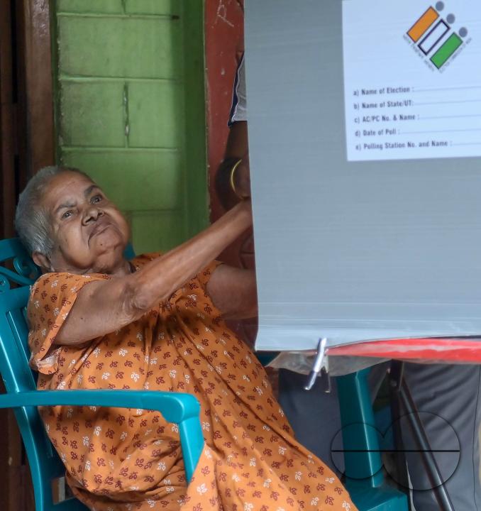 A 104-year-old woman cast her vote through a postal ballot with the assistance of a family member at her home in Agartala, under the supervision of election officials and security personnel