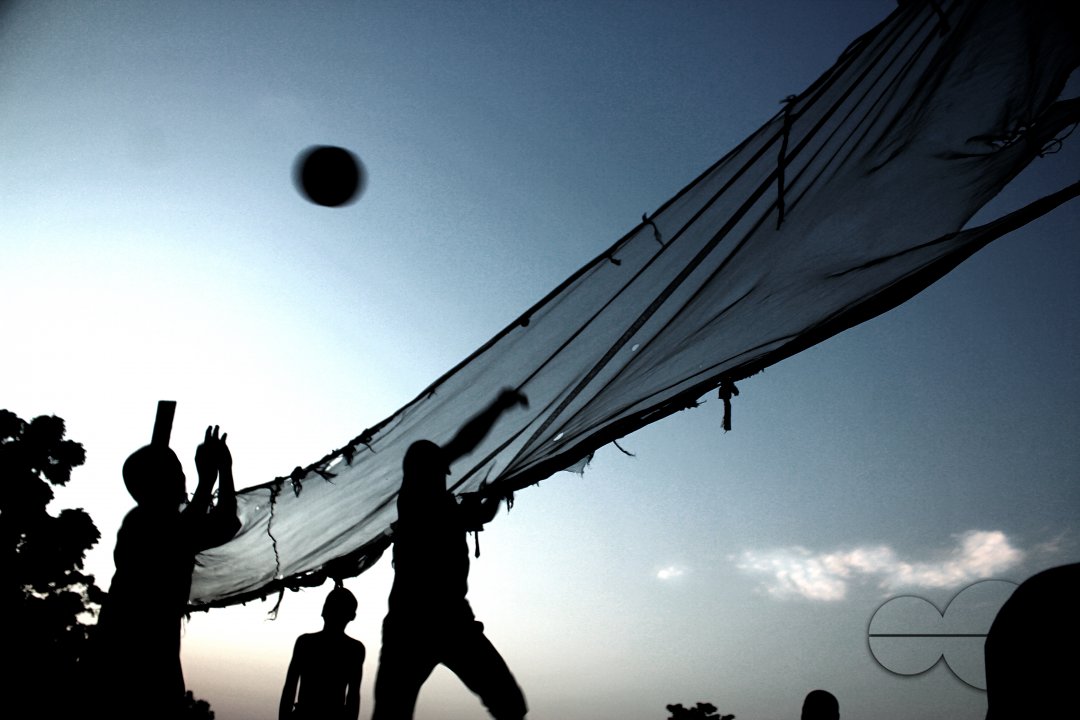 Children play volleyball at Deeper Life Camp Ground, a non-governmental camp for displaced persons a