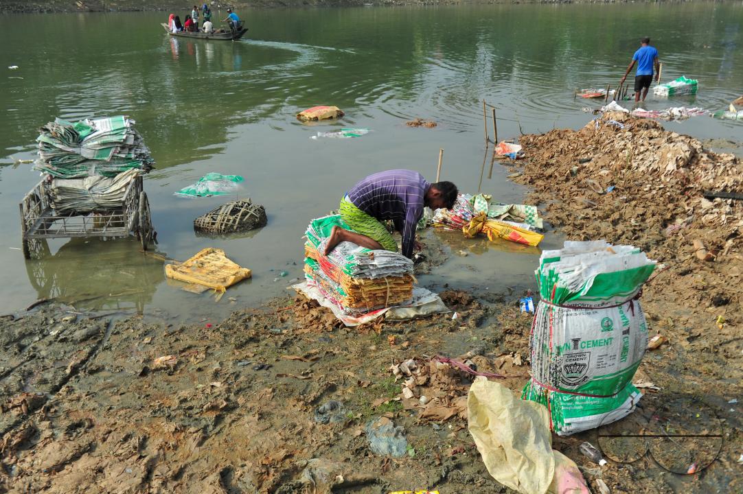 Women are risking their lives to wash cement bags beside the Surma River in Sylhet