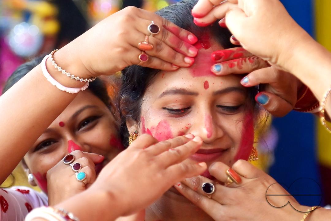 Married women smear each other with vermillion during a ritual called the vermillion game, or "Sindur Khela," on the last day of the Durga Puja festival in Agartala, Tripura, India.