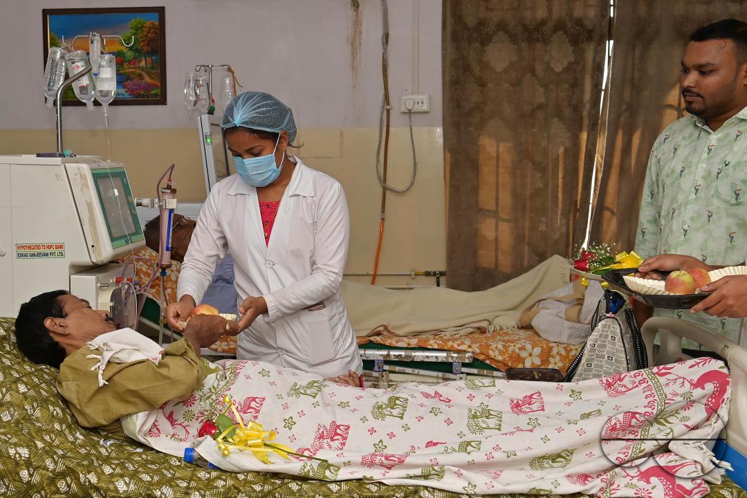 Doctors, along with health workers, distribute roses and fruits during the celebration of World Kindness Day in the dialysis ward at IGM (Indira Gandhi Memorial) Hospital in Agartala
