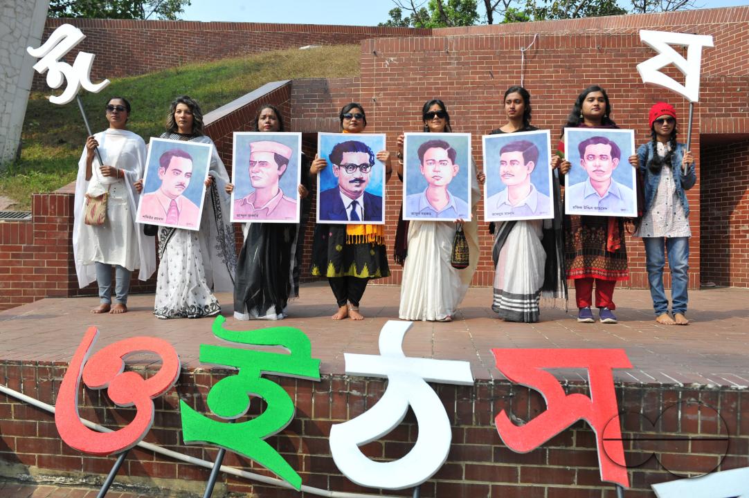 Culture activists at an alphabet march holding pictures of language martyrs to celebrate Language month with an alphabet procession in Sylhet