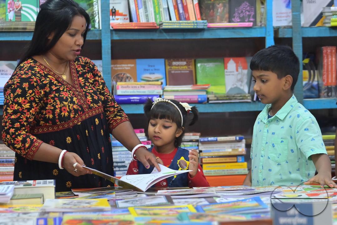 Children looking at books in a book stall at the 42nd Agartala Book fair International Fair Ground, Hapania at Agartala