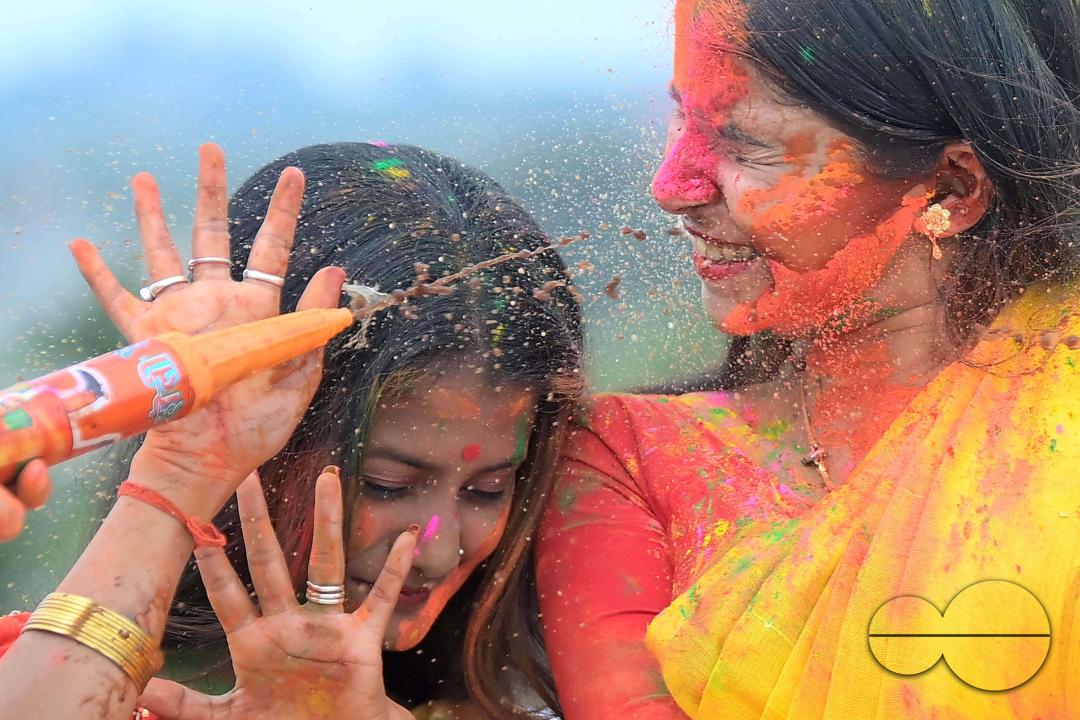 Indian girls adorned with 'Gulal' or coloured powder during the Hindu spring festival 'Holi', the festival of colour in Agartala