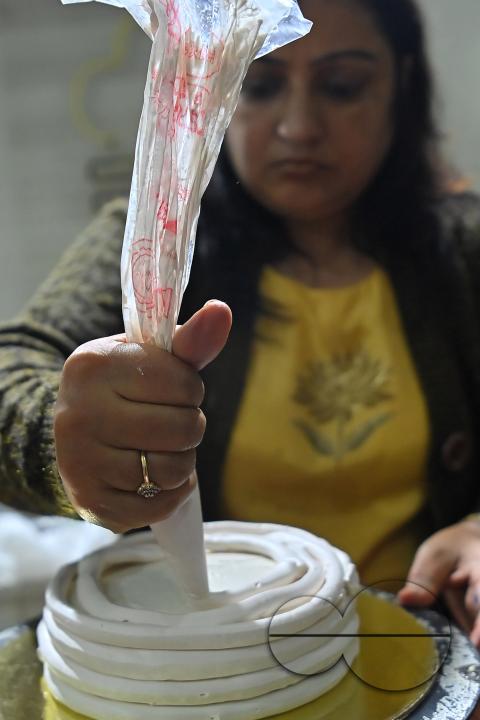 Sutapa Choudhary, a cake artist and teacher, making cakes at her cake parlour, "CREAMY DELIGHTS"