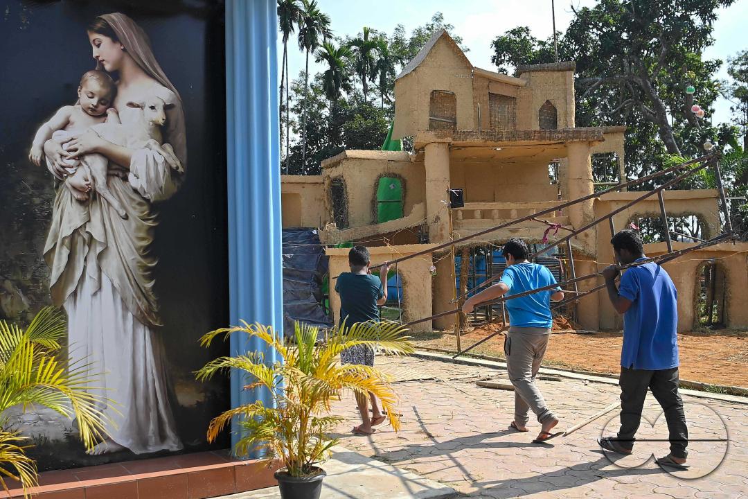People decorate a church in preparation for Christmas Day at Mariam Church, Agartala