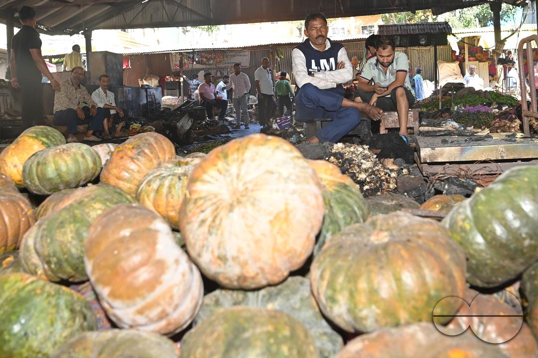 Shop owners and vendors are seen in front of their burnt shops and vegetables stalls in Battala market, the second biggest market in Tripura