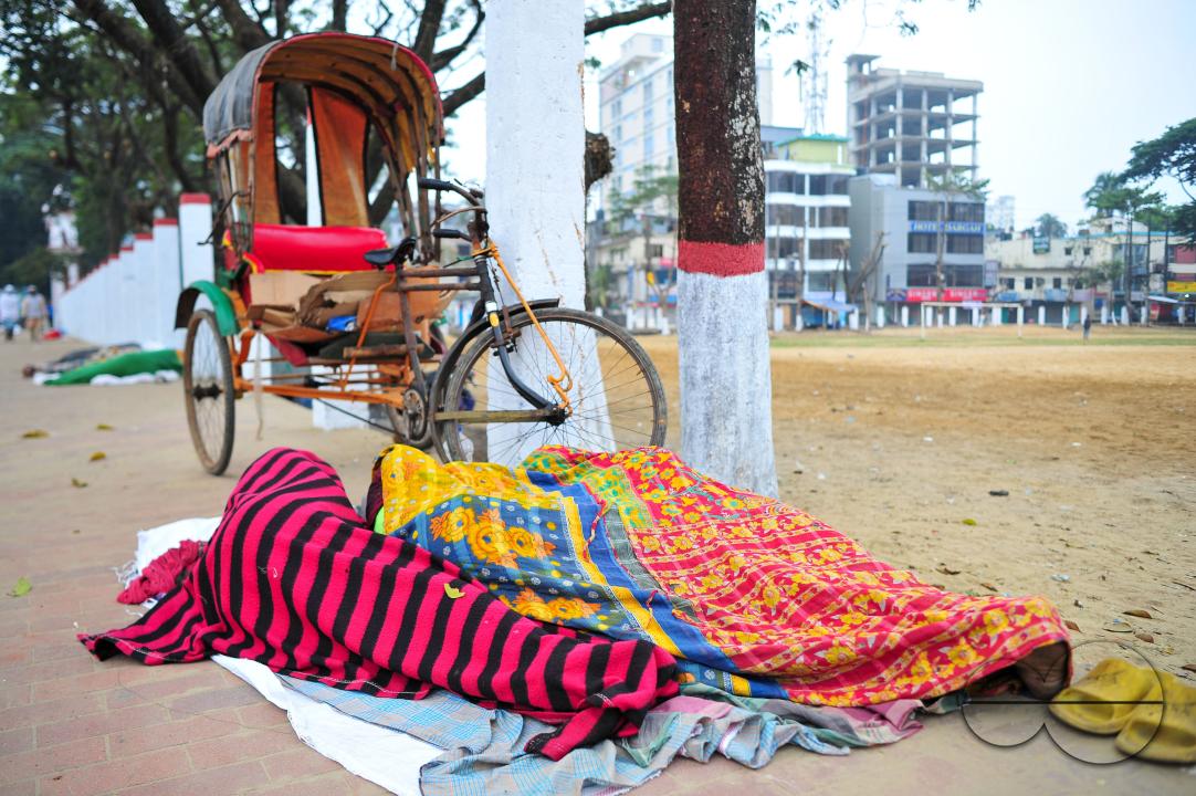 Covering their bodies from head to toe with whatever they can manage, homeless people sleep out in the open in the shivering cold near the Government Alia Madrasa in Sylhet city's Chowhatta area