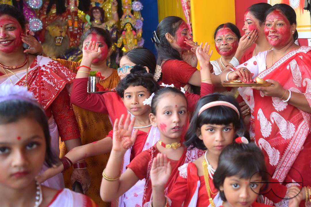 Children and married women are dancing, and the women smear each other with vermillion during a ritual called the vermillion game, or "Sindur Khela," on the last day of the Durga Puja festival in Agartala, Tripura, India.