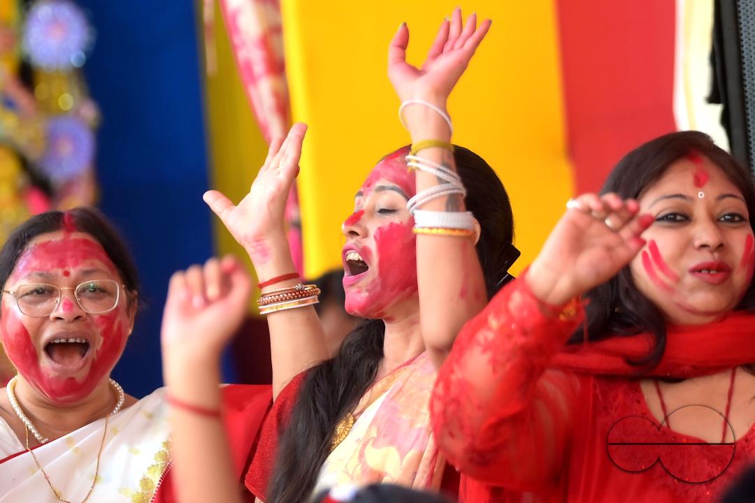 Children and married women are dancing, and the women smear each other with vermillion during a ritual called the vermillion game, or "Sindur Khela," on the last day of the Durga Puja festival in Agartala, Tripura, India.