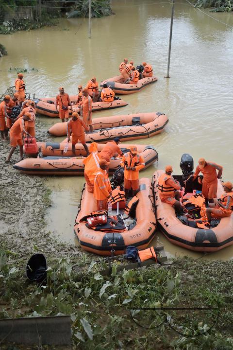 NDRF (National Disaster Response Force) personnel are seen preparing themselves to rescue people from a flooded village in the outskirts of Amarpur city, 82km away from Agartala