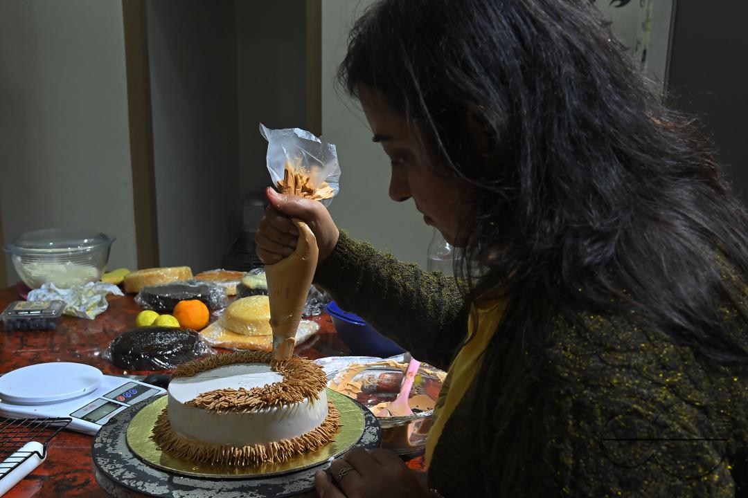 Sutapa Choudhary, a cake artist and teacher, making cakes at her cake parlour, "CREAMY DELIGHTS"