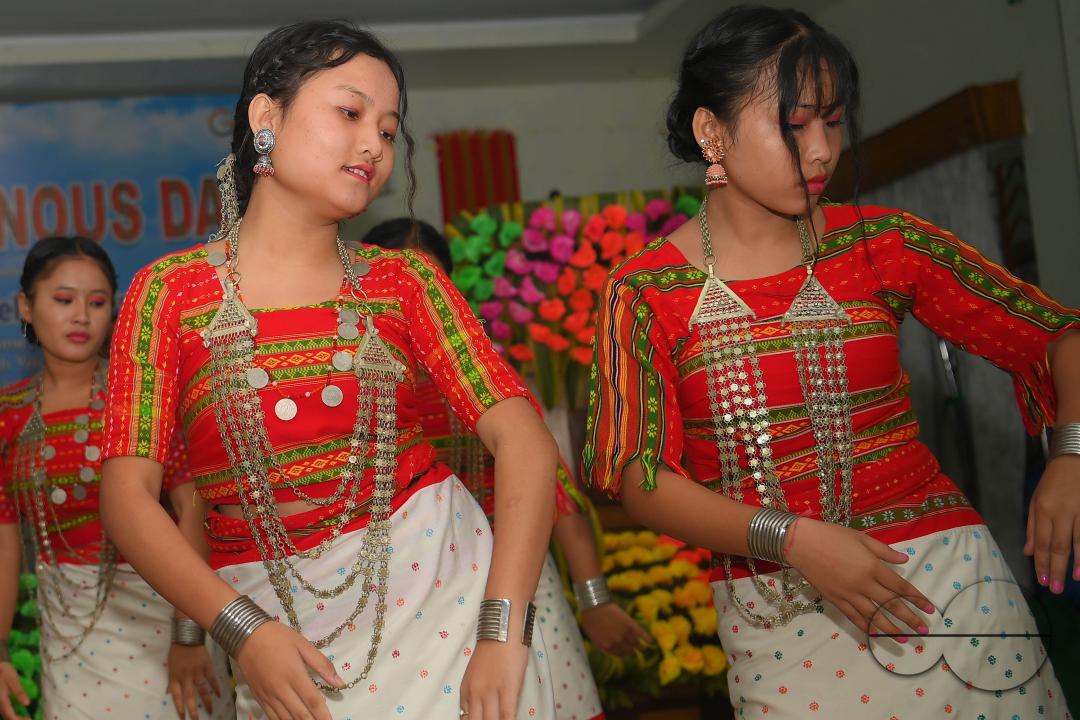 Indigenous girls perform traditional dances on the occasion of World Indigenous Day in an auditorium at Agartala