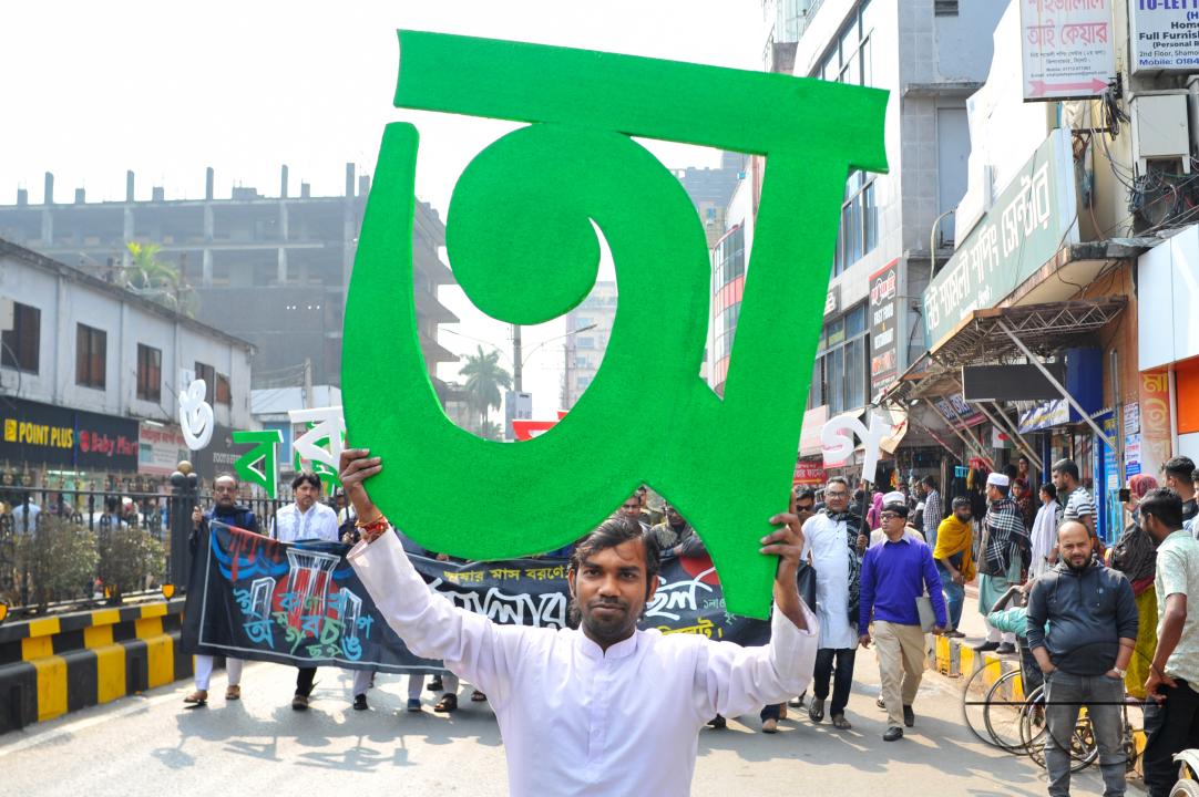 A big bangla alphabet in the hand of a cultural activists at Sylhet Central Shaheed Minar which was celebrated with an alphabet procession in Sylhet