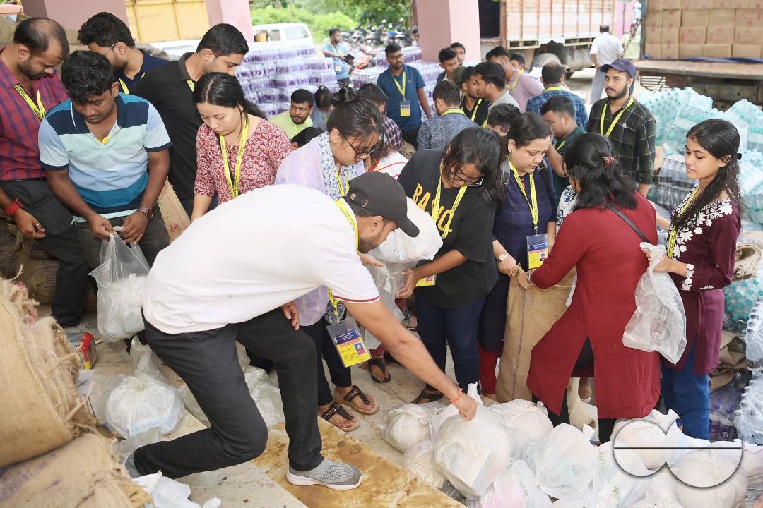 Government officials and workers are preparing food packets to be distributed by NDRF (National Disaster Response Force) personnel from helicopters to flood victims in different parts of Tripura