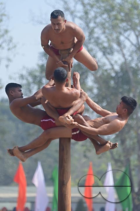 Police officials perform Mallakhamb, a traditional sport, in celebration of 150 years of Tripura Police Week at the stadium of A.D
