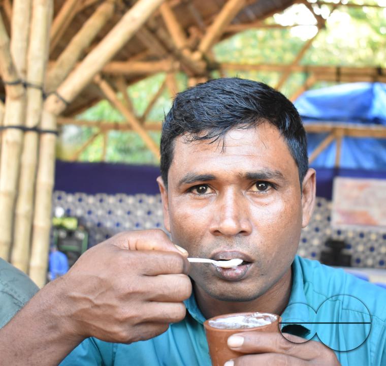 Portrait of a man eating at the Balukhali refugee camp