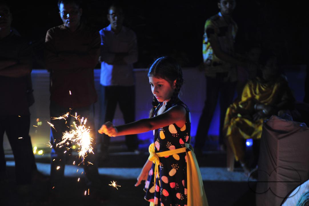 Little girls are lighting fire sparks to celebrate Prabarana Purnima 2023 at Buddhist temples in Sylhet