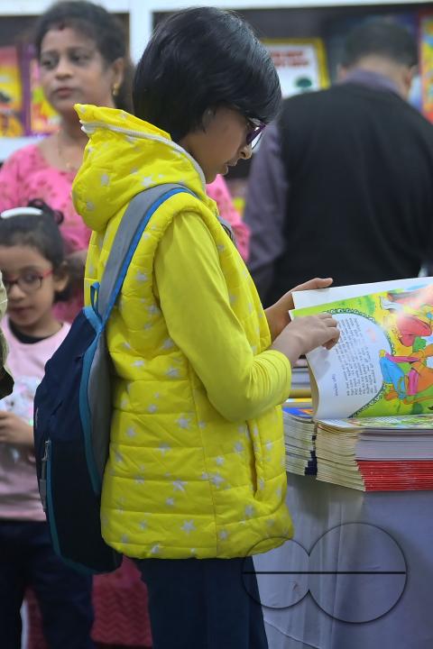 Children looking at books in a book stall at the 42nd Agartala Book fair International Fair Ground, Hapania at Agartala