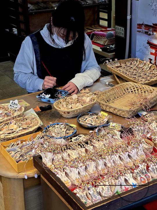 Local craftsperson painting on wooden artefacts in Hiroshima